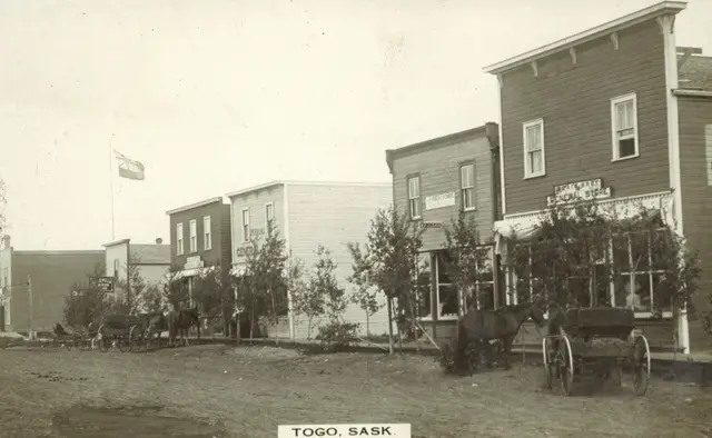 Main Street with general store and horse-drawn buggies